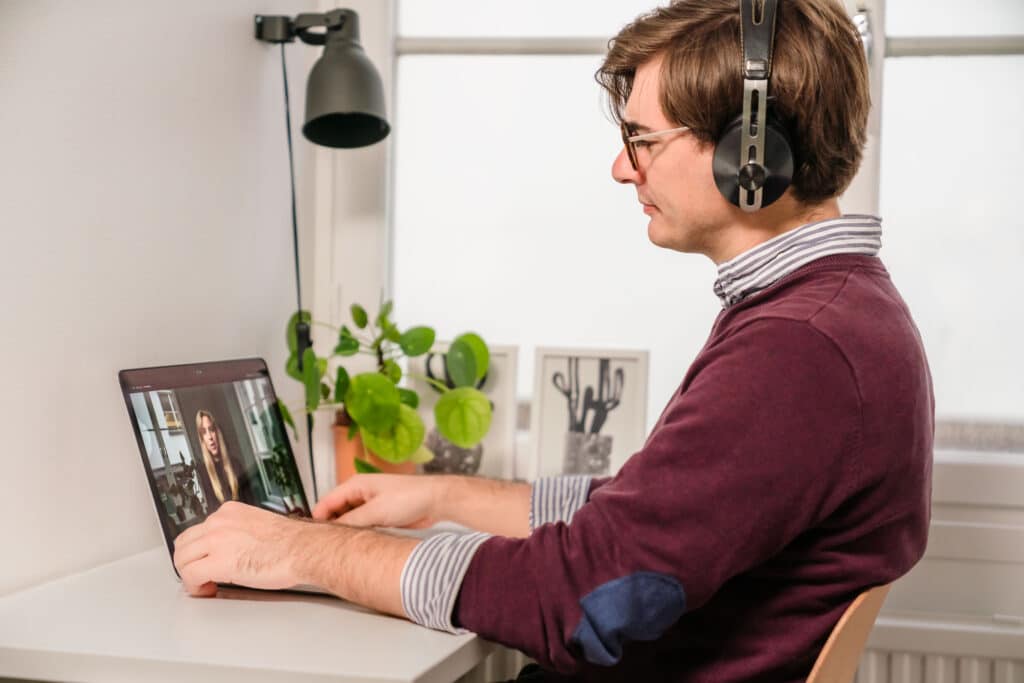 Co-worker sitting in front of the computer partaking in a workshop